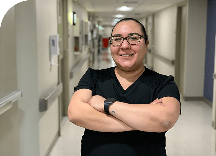photo of Melissa Carrillo standing in a hospital hallway, arms crossed