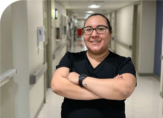 carillo_rdclg - Texas Hospital Association photo of Melissa Carrillo standing in a hospital hallway, arms crossed