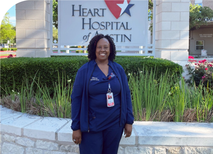 photo of Inger Glasper standing outside in front of a Heart Hospital of Austin sign