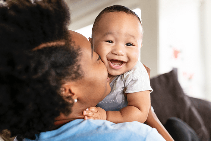 happy mother kissing her baby son