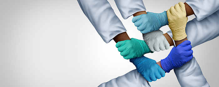 hands in medical gloves criss-crossed to hold each other's wrist