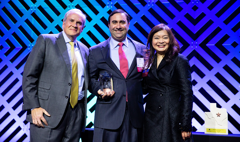 Ross Korkmas was presented with the 2021 Pioneer Award by THA CEO John Hawkins (left) and THA board chair-elect Erin Asprec (right)