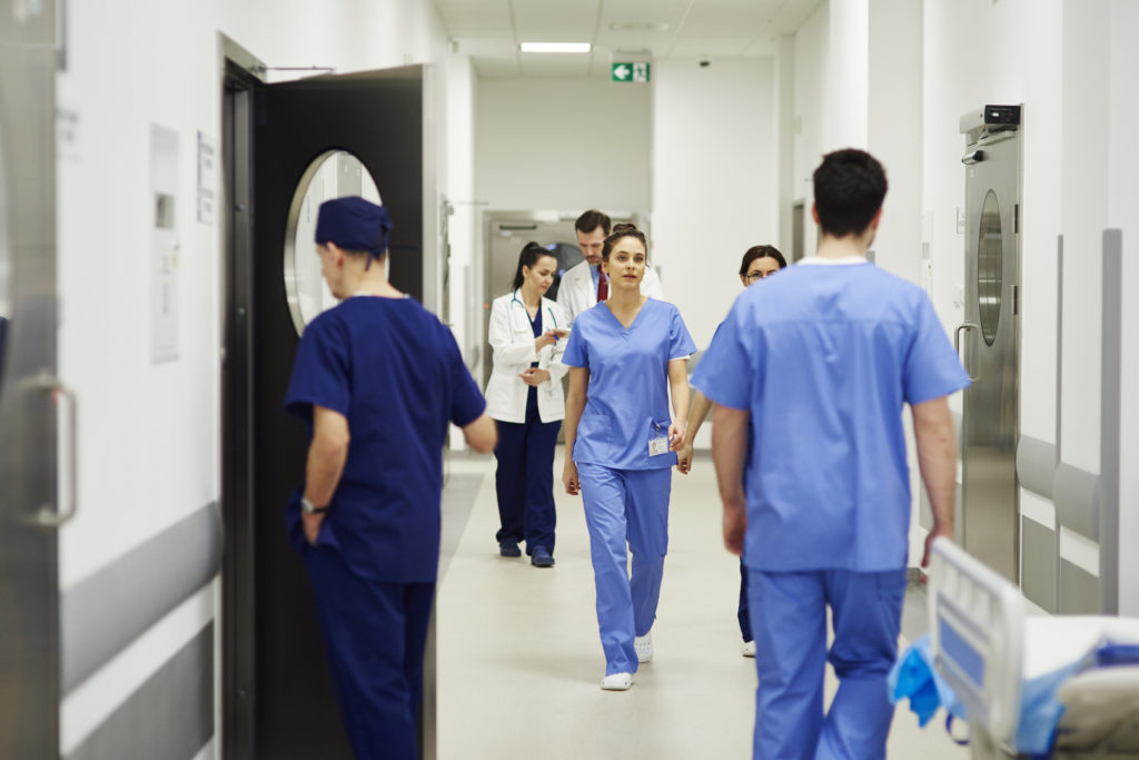 Doctors walking through corridor in hospital - Texas Hospital Association