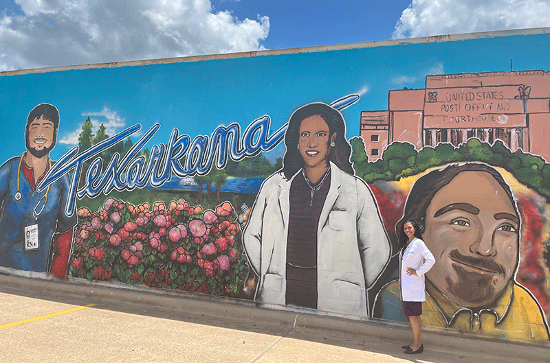 Robinson with a mural in Texarkana that features her as a community leader