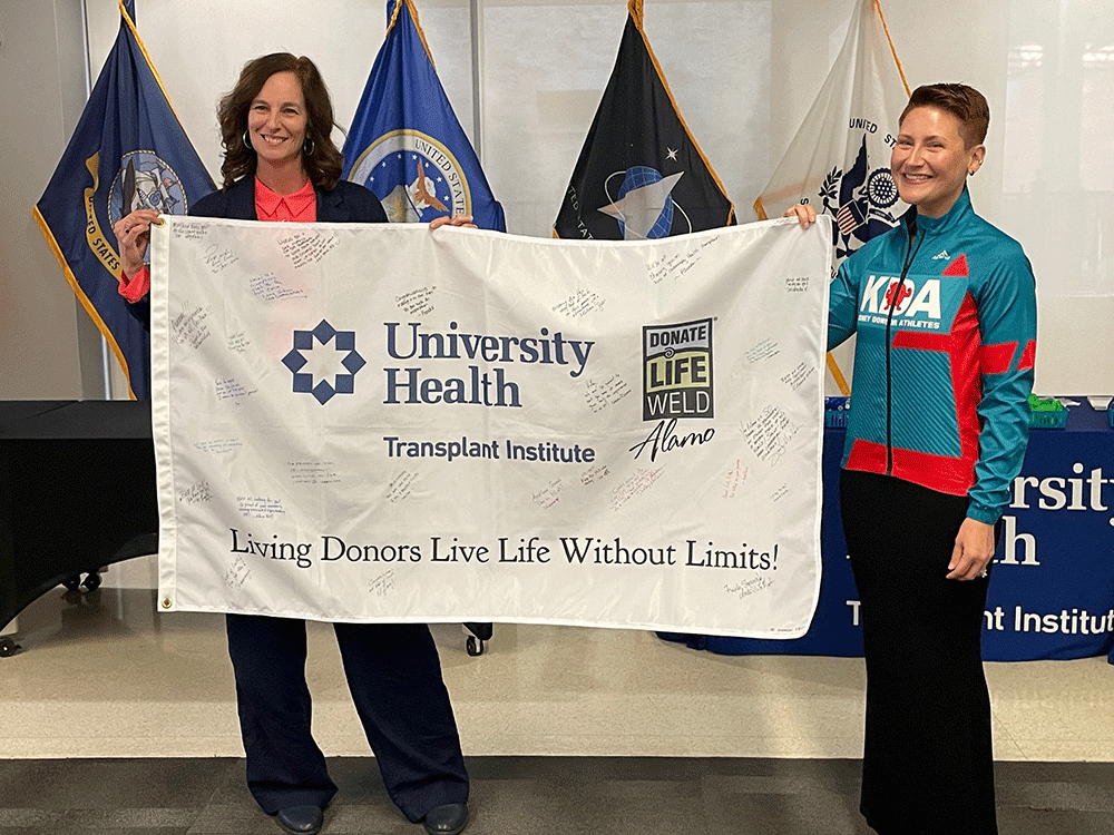 University Health Transplant Institute administrator Jennifer Milton and Kelley HItchman with flag