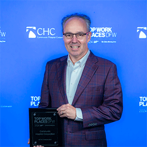 Jim Kendrick holding CHC’s 2024 Top Workplace award from Dallas Morning News.