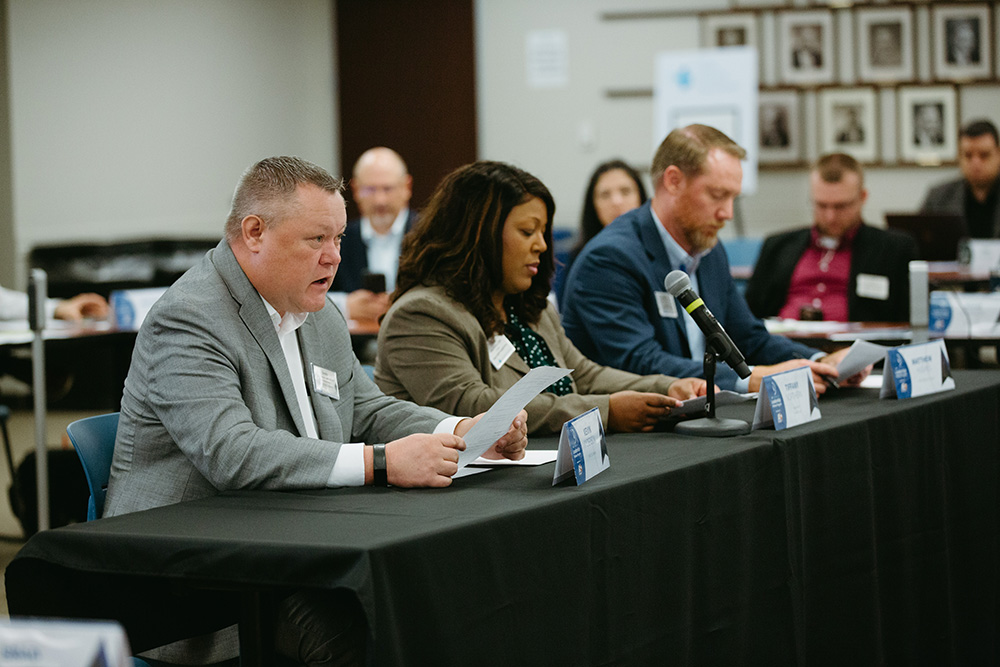 THA Fellows Class of 2026 during a mock testimony - Texas Hospital Association Panelists sit at a long table with microphones and papers during a formal discussion or hearing.